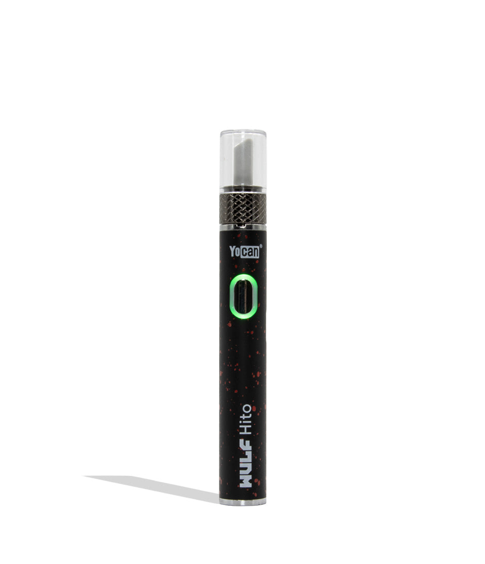 Yocan WULF Mods Hito Knife Kit device 510 battery with a glowing green power button, standing upright on a white background with a soft shadow. black red spatter