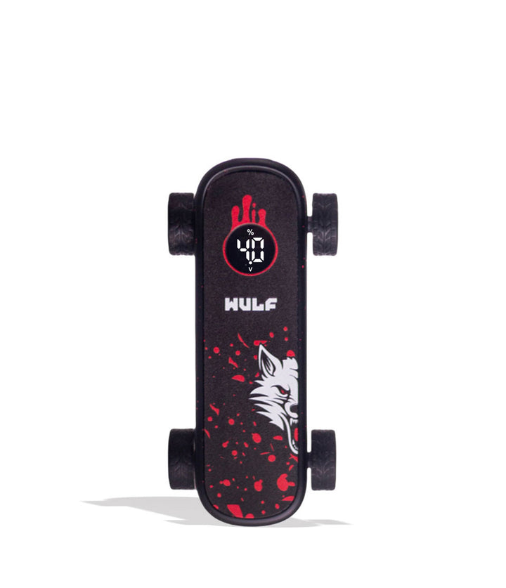 A miniature black skateboard with red splatter graphics, a white wolf head graphic, and a circular red and black logo near the front. The brand name &