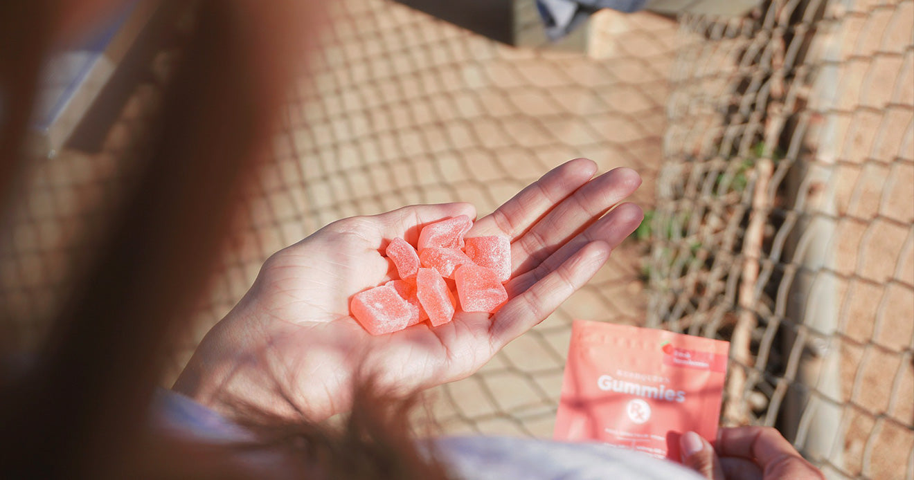 Orange gummies in palm of hand
