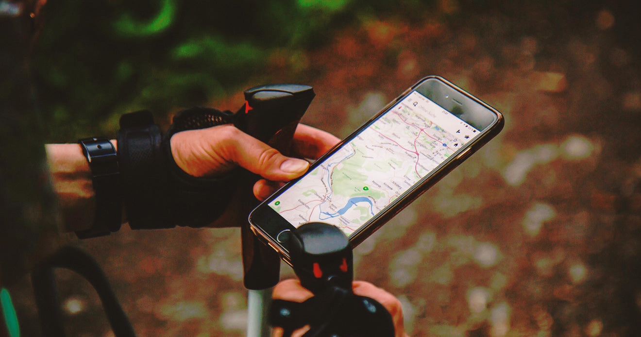 Man in hiking gear looking at his GPS on his phone