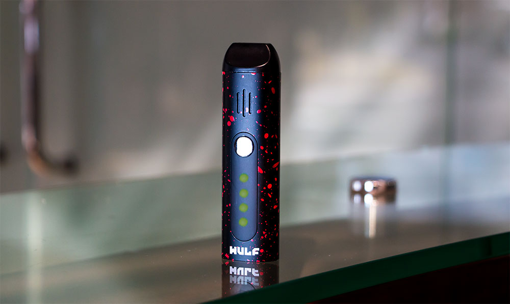 WULF Flora portable dry herb vaporizer standing on a dark surface