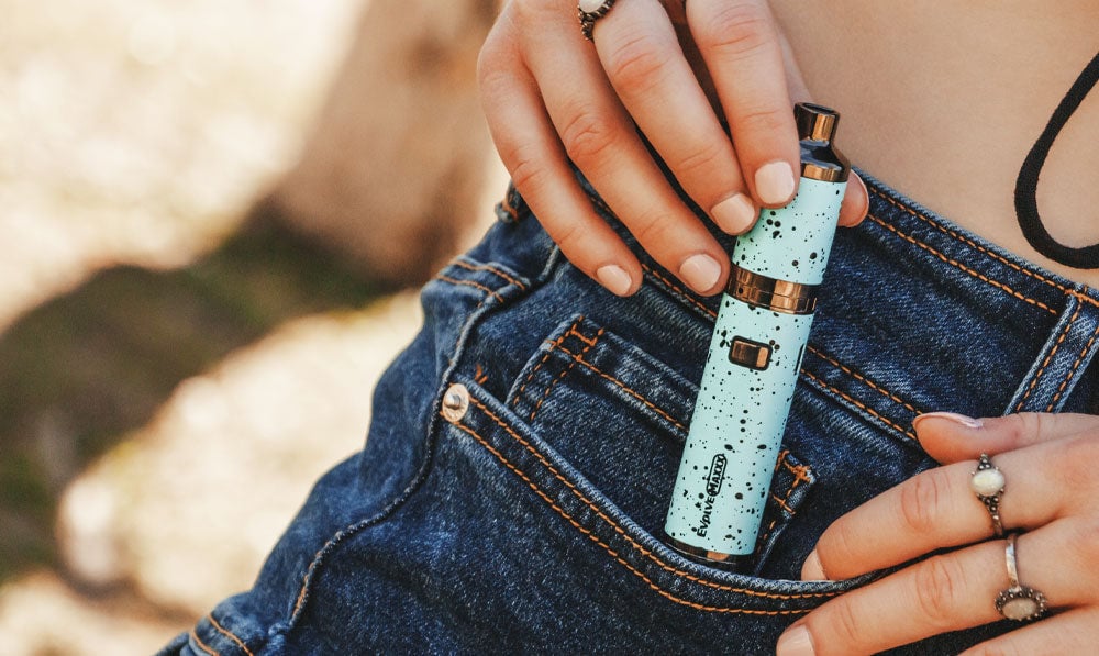 Teal Black Spatter Wulf Mods Evolve Maxxx being placed in woman's pocket