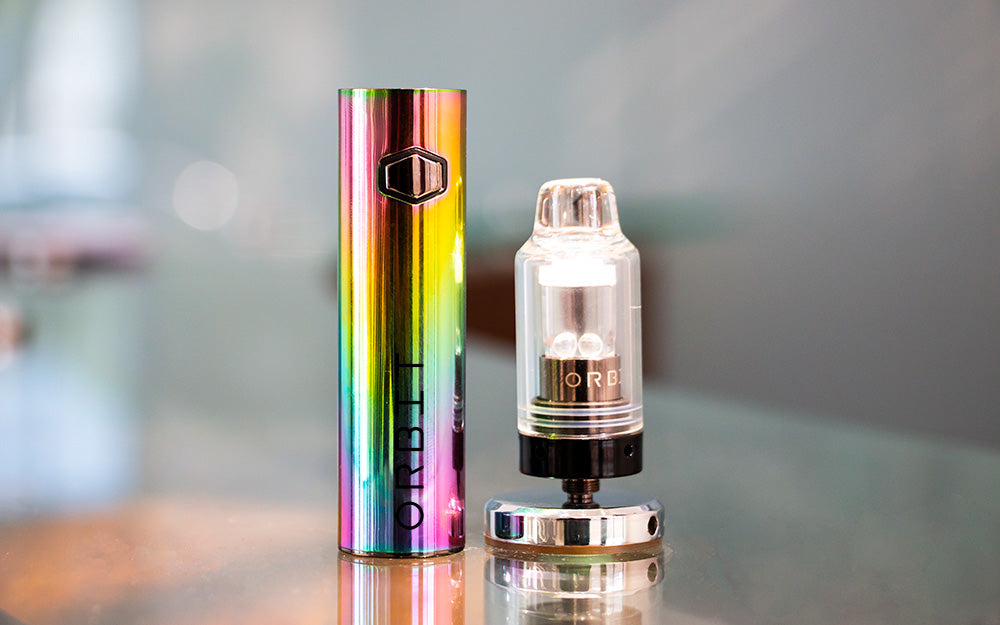 WULF Orbit concentrate vaporizer in a rainbow finish with its glass attachment