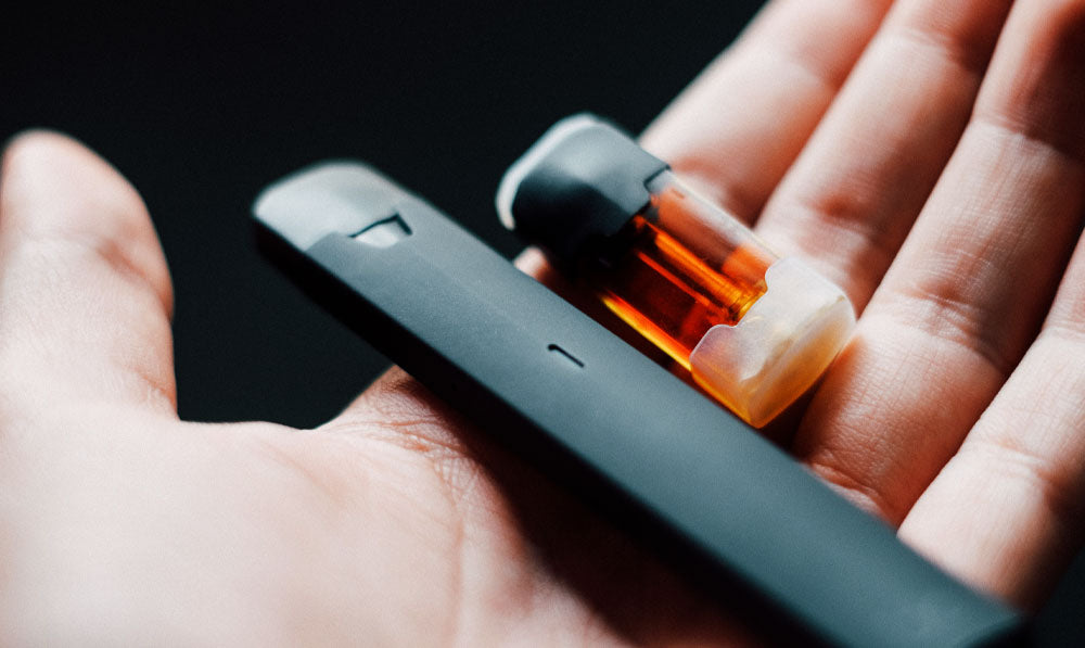 Vape and Pod in random person's hand