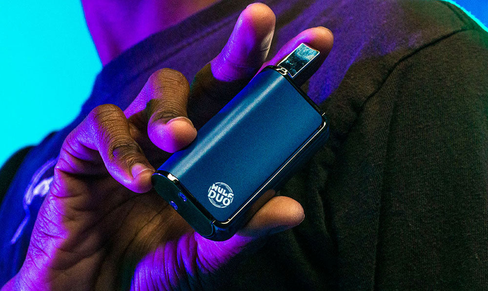 Wulf Duo in man's hands in front of blue studio lighting