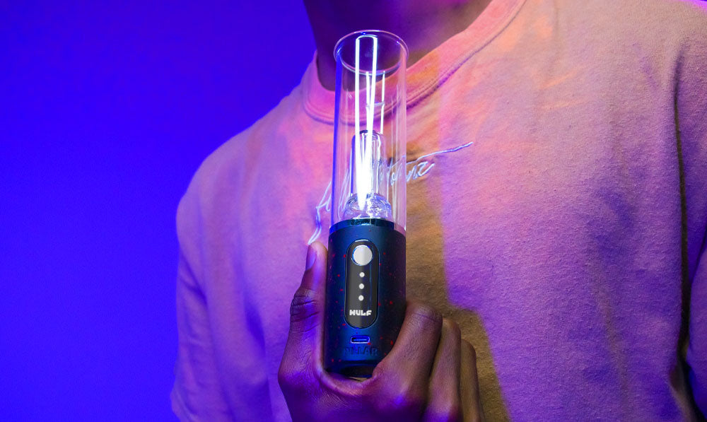 Man holding Wulf Mods Pillar in front of purple blue studio background