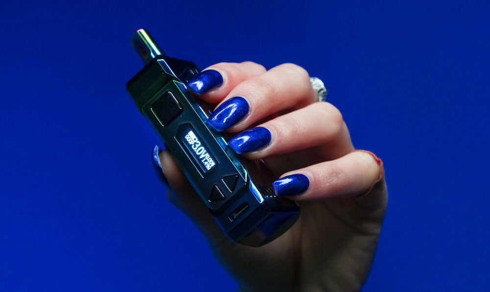 Woman holding Wulf UNI Pro Max in front of blue studio background