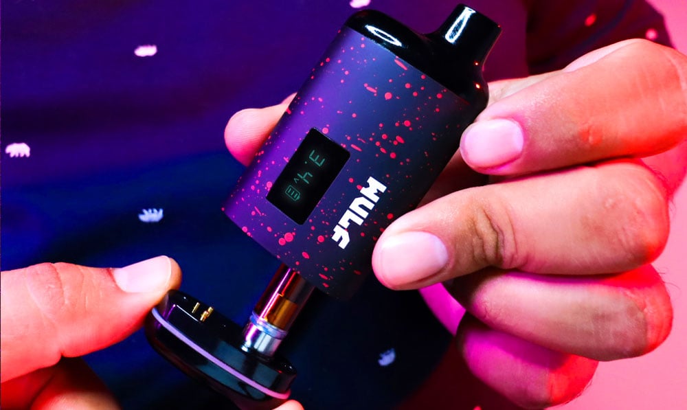 Man holding Wulf Recon apart under soft red lighting