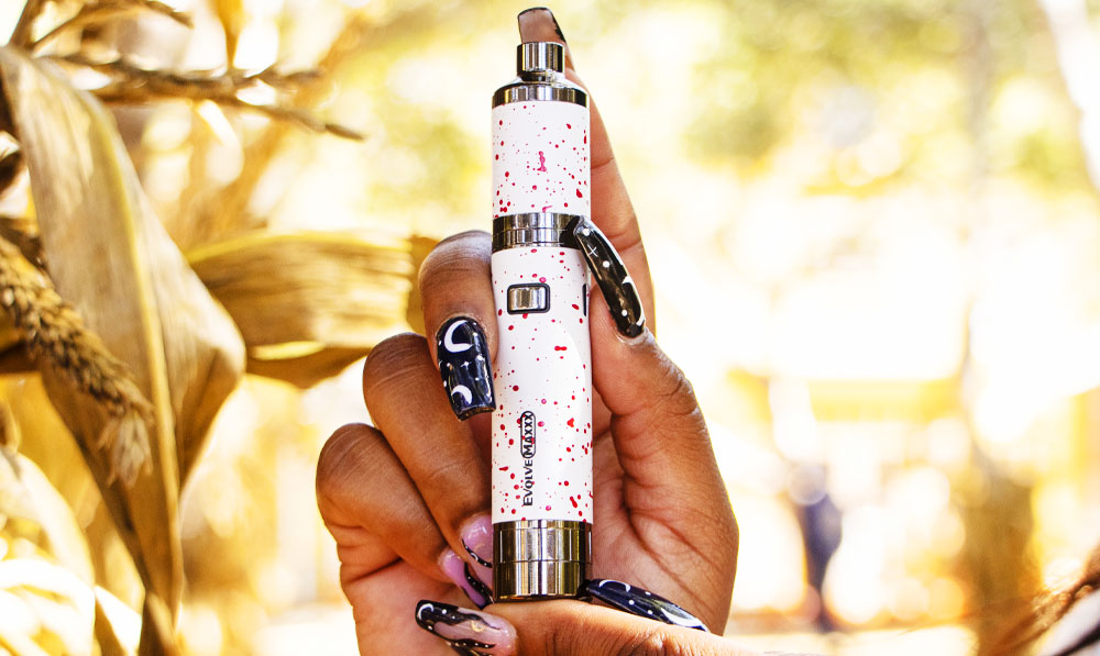Woman holding Wulf Evolve Maxxx in front of pumpkin patch in autumn weather