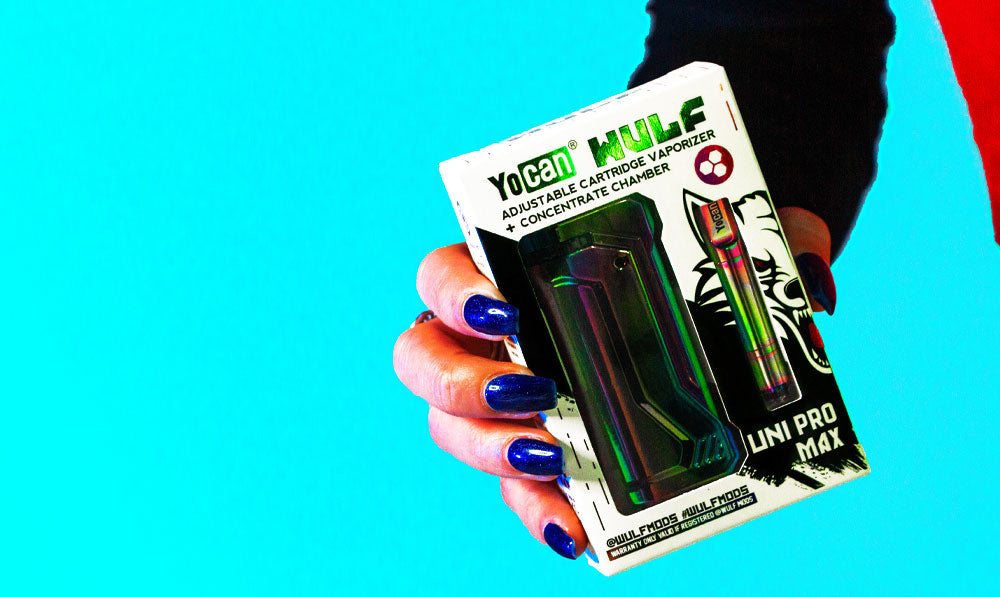 Woman holding Wulf UNI Pro Max in front of blue studio background