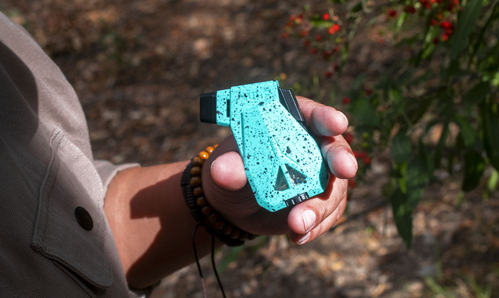 Man holding Wulf Speed torch in front of grassy plain