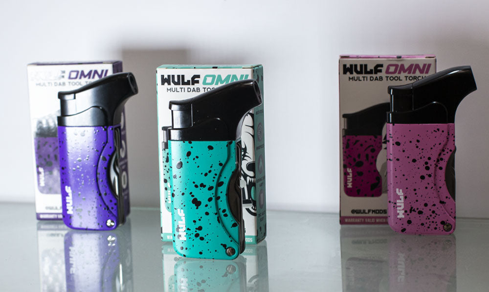 Wulf Omni torches standing in front of packaging in front of white wall