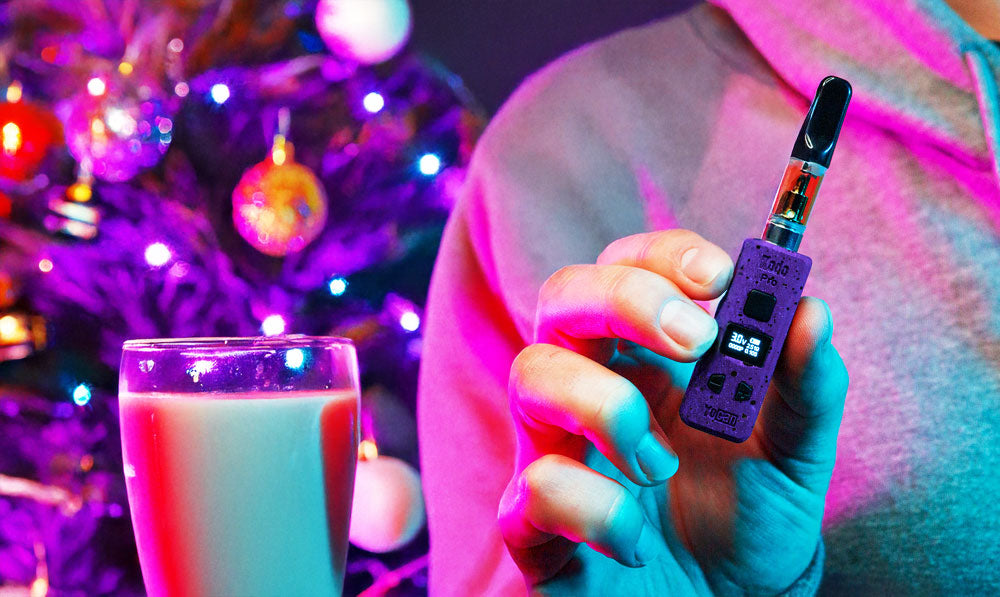 Man holding Wulf Kodo Pro near Christmas tree with horchata drink in focus