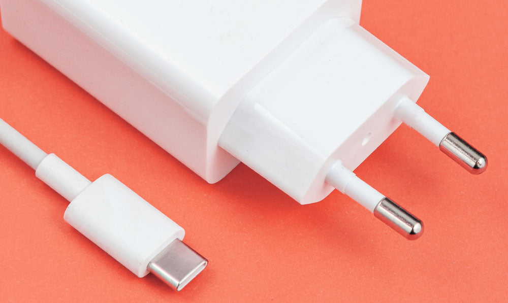 USB C Charger resting on orange surface