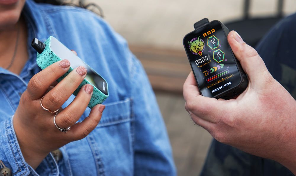 Two people each holding Recon Pro outside