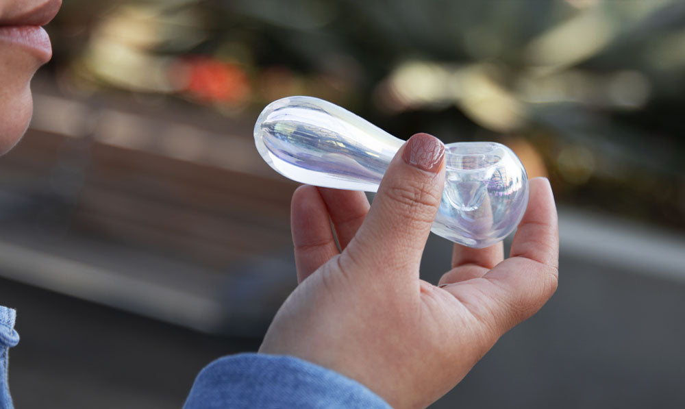 Woman holding clear Wulf Globe at park