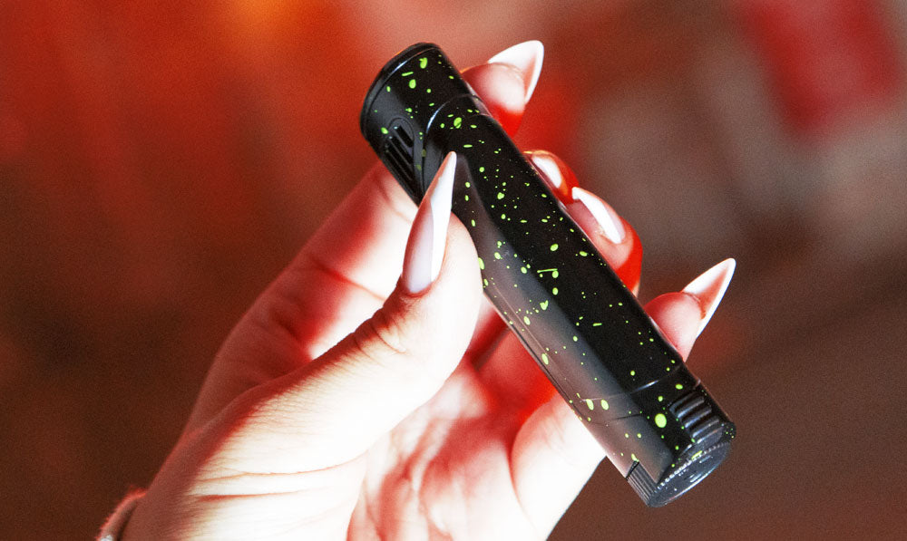 Woman holding black green spatter Wulf Blitz Torch