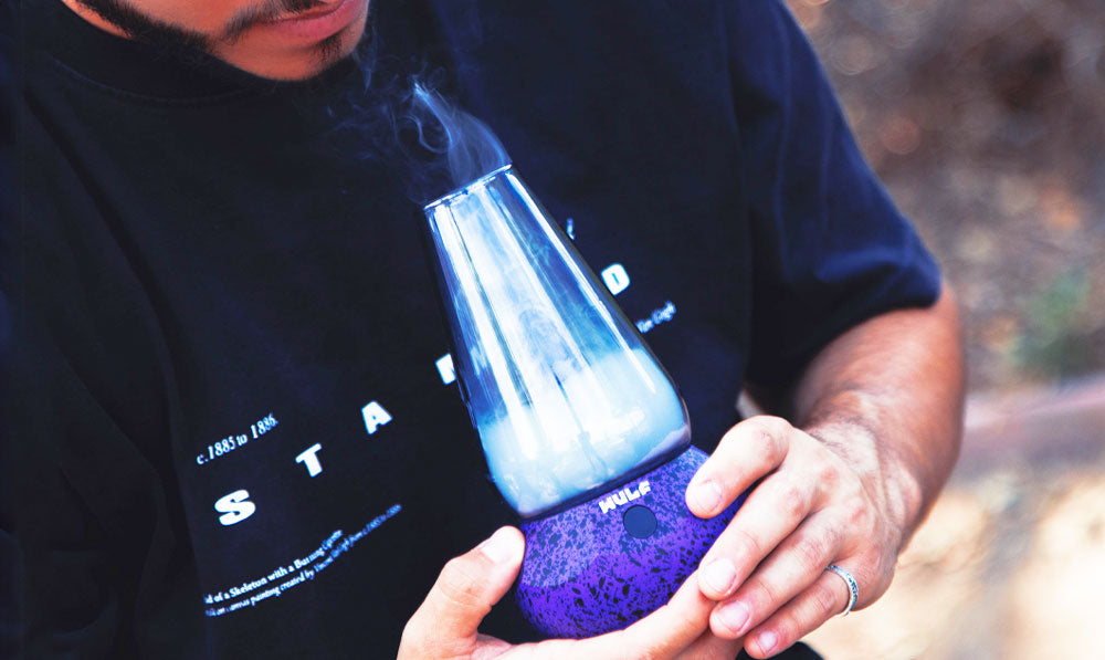 Man holding Wulf Fang with smoke rising to the surface