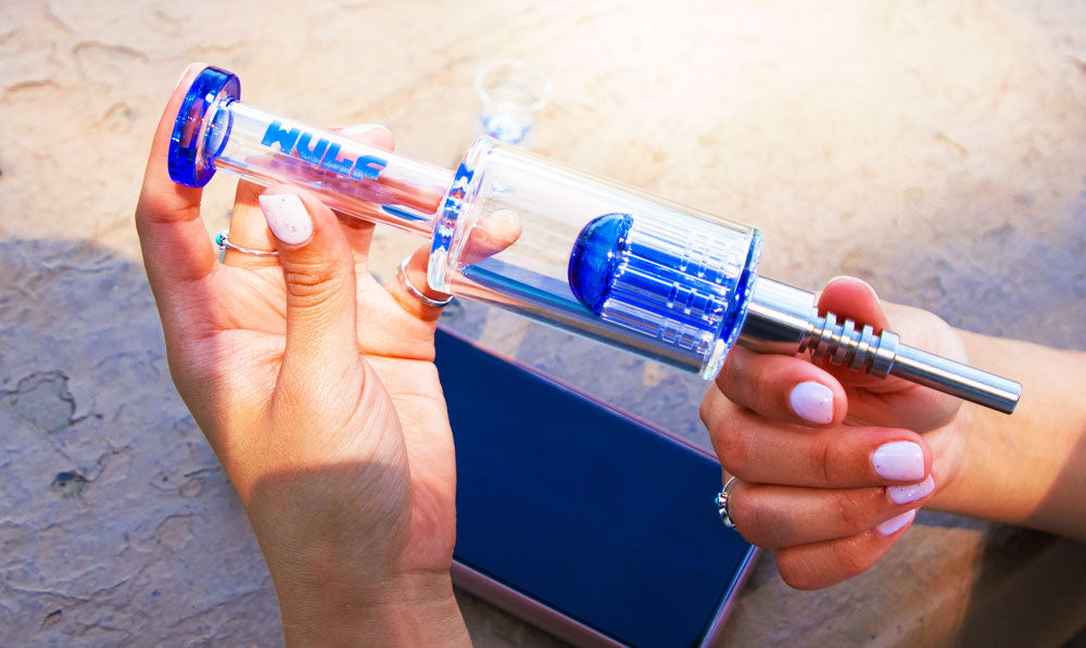 Woman holding Blue Wulf Mods Timber over a cell phone at a park table