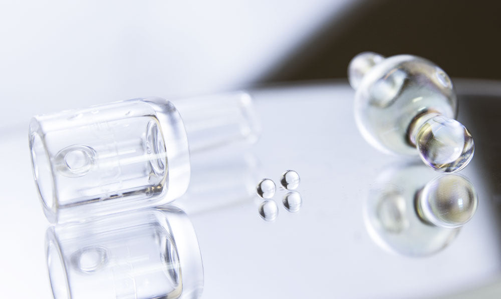 WULF Atom glass accessories on a reflective surface