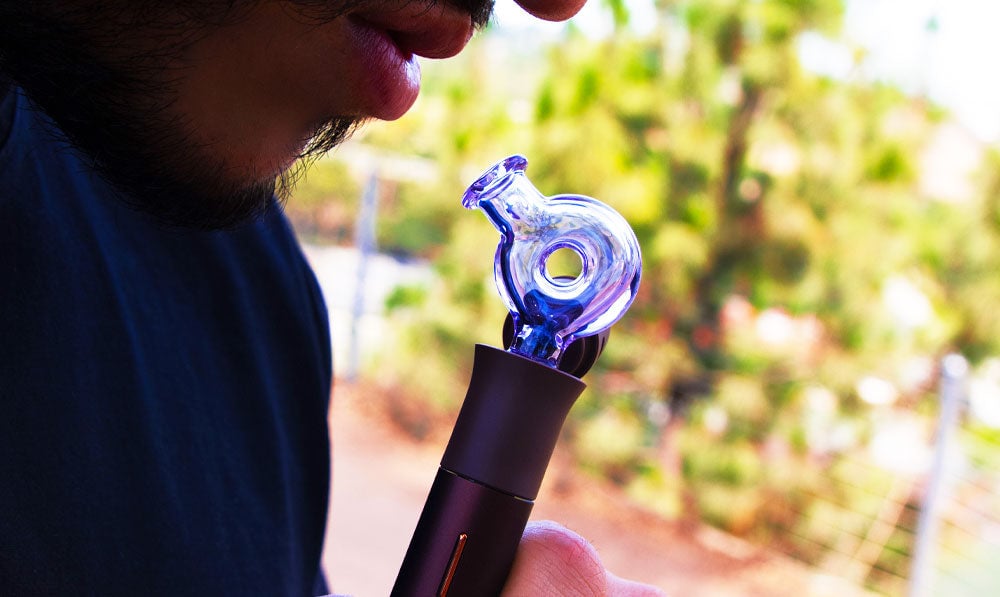 Close up of a person using a WULF Ring Pivot glass top