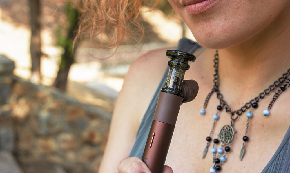 Person holding a WULF Tower with a pivot attachment outdoors