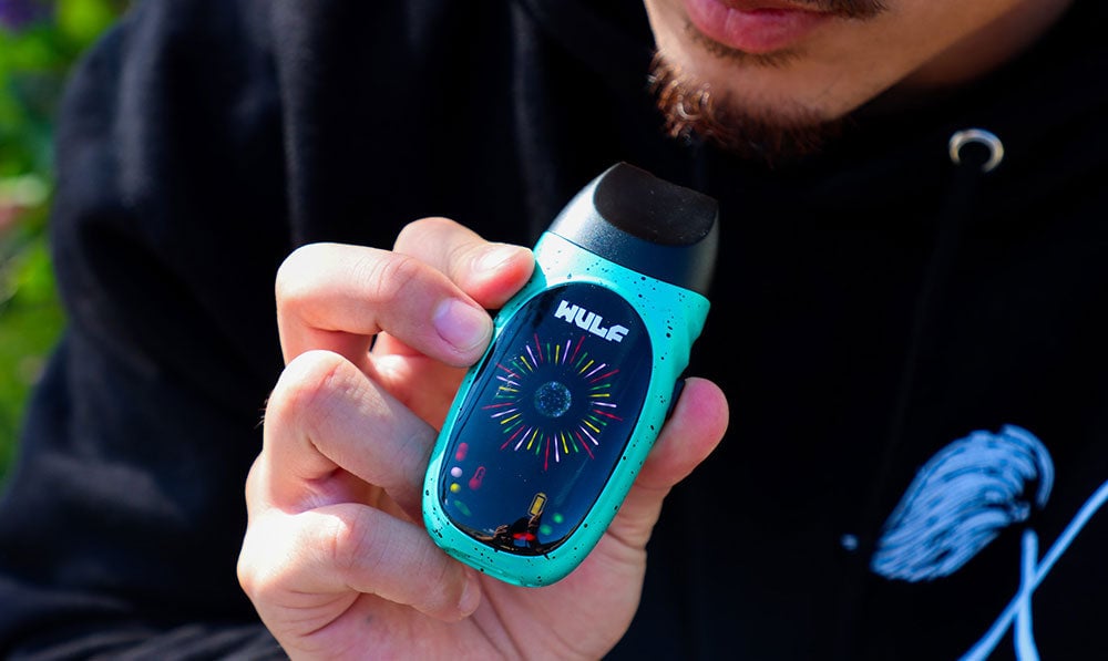 man using Wulf Faze Dry Herb Vaporizer outside