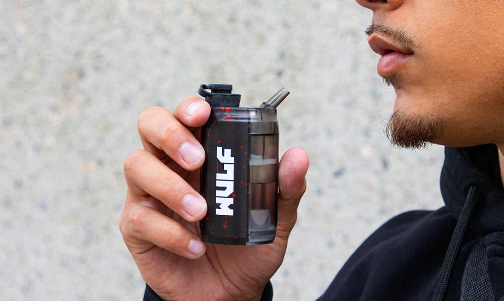 man putting Wulf Growler up to his mouth to smoke out of