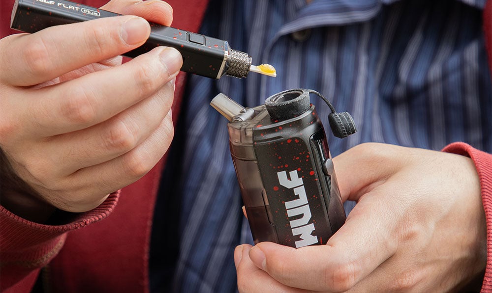 hands holding Wulf Growler loading it up with wax on lifestyle background