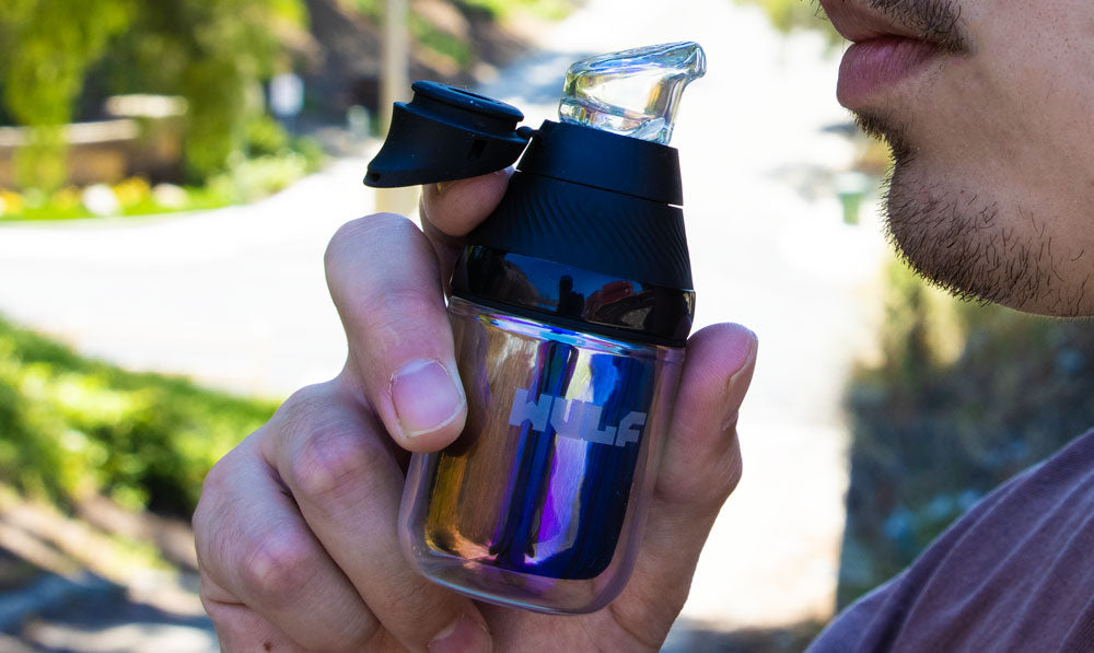 Person holding a WULF Nest Puffco Proxy core attachment fitted to a Proxy