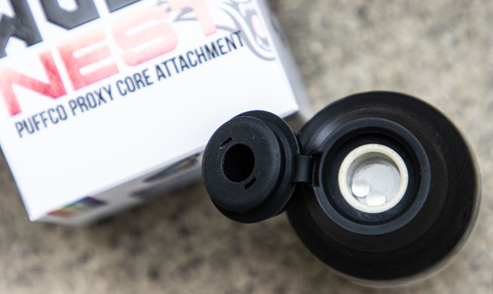 WULF Nest Puffco Proxy core attachment beside its retail box, viewed from above