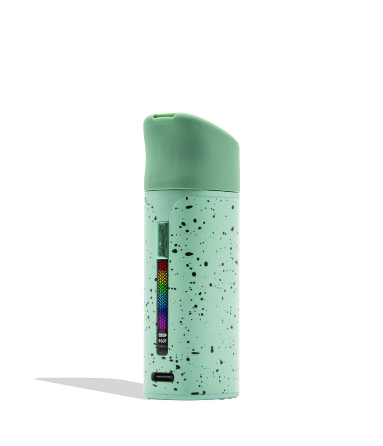 WULF MODS Pocket Mini portable concentrate vaporizer in teal/mint with black spatter pattern details, featuring a vertical rainbow LED indicator light on the side, shown against a plain white background.