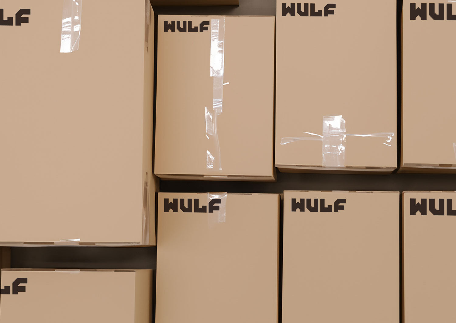 Stacked plain brown shipping boxes printed with the WULF logo