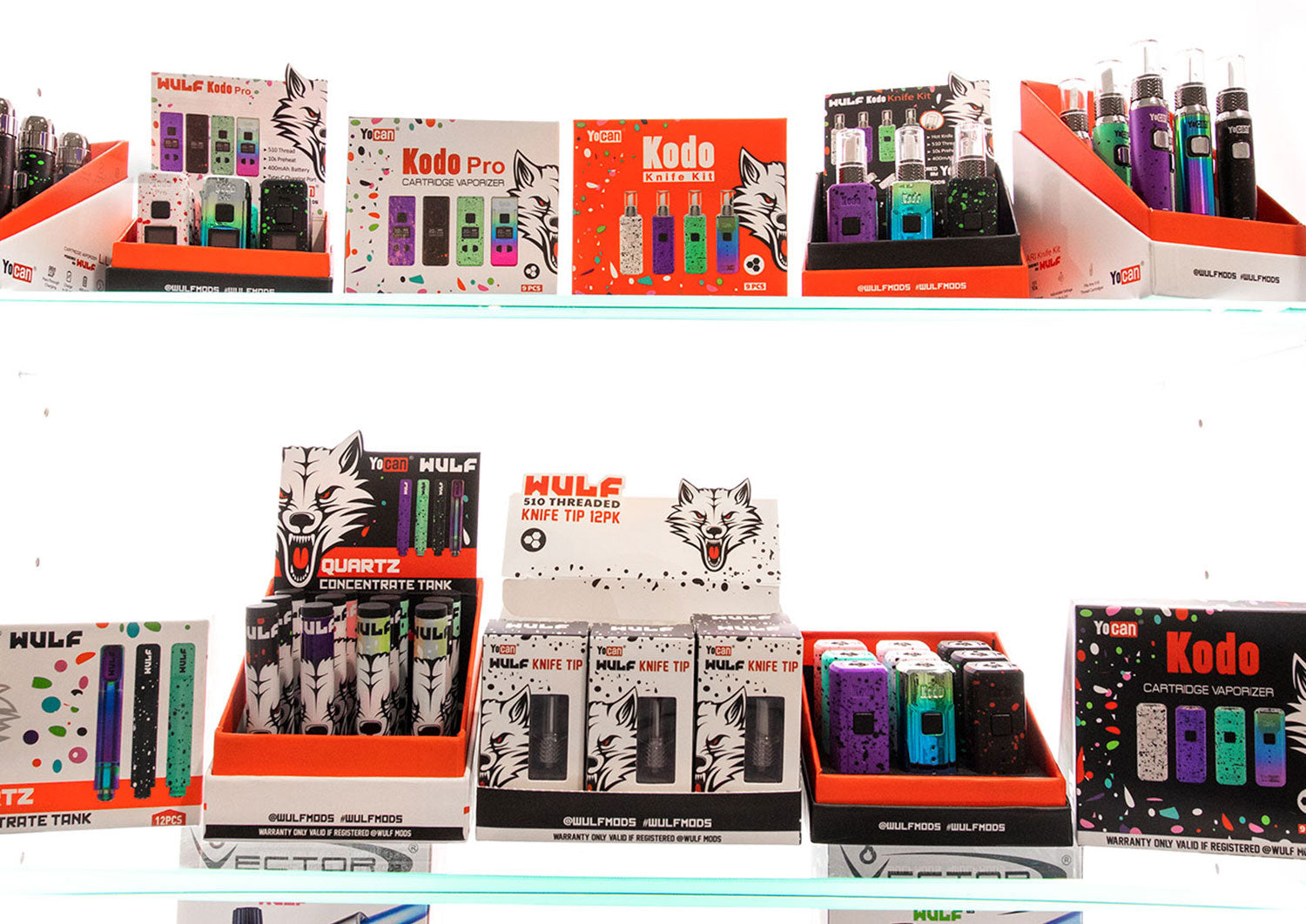 Retail shelf stocked with WULF and Yocan Kodo countertop display boxes