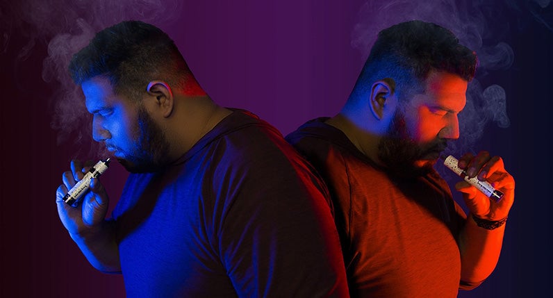 Man using both wax pen and dry herb mode for evolve plus XL Duo