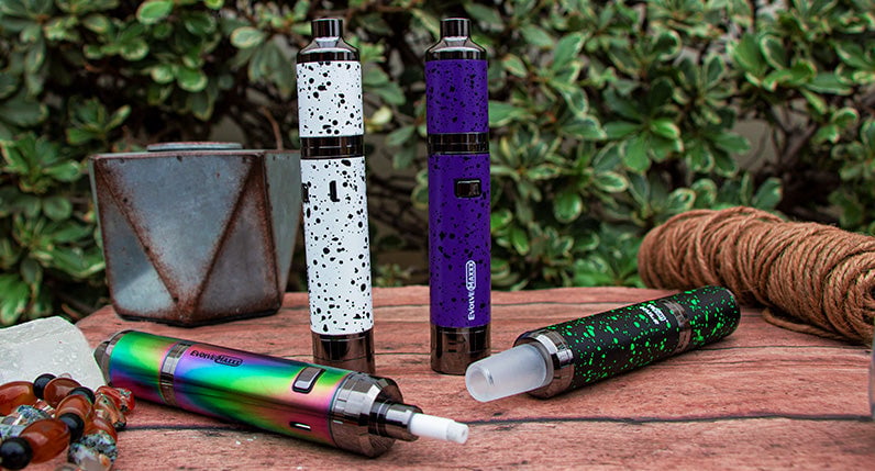 WULF Evolve Maxxx three in one vaporizers standing among foliage