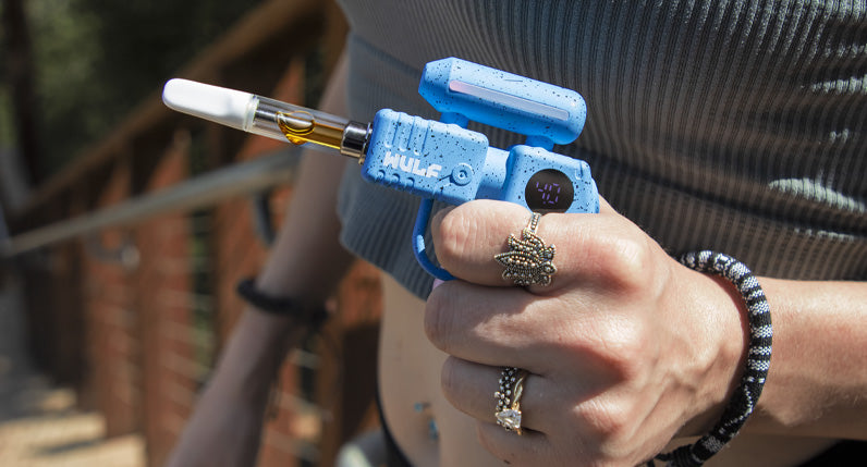Person posing on a staircase holding a blue WULF Zapp 510 thread battery