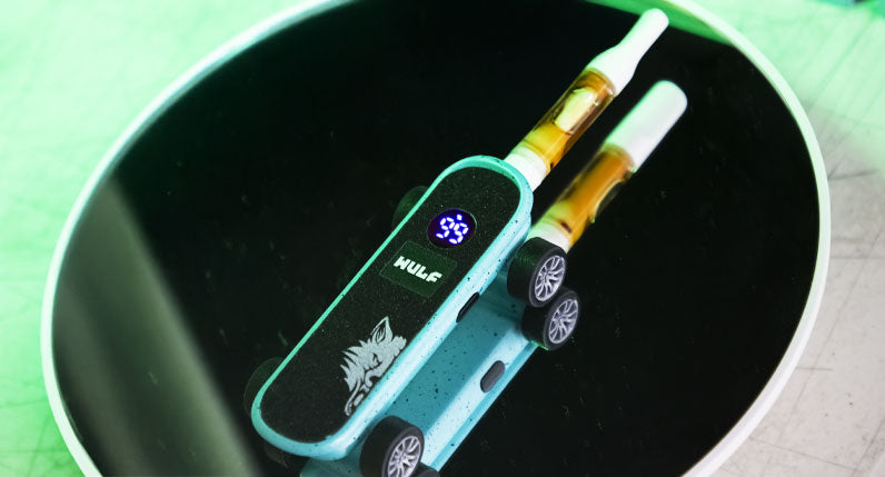 WULF Deck skateboard shaped 510 thread battery resting in a green bowl