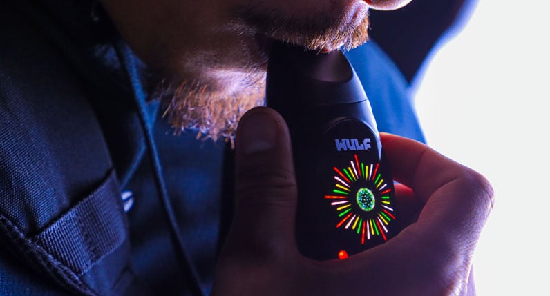 WULF Faze clipped to a blue jacket with its LED screen lit
