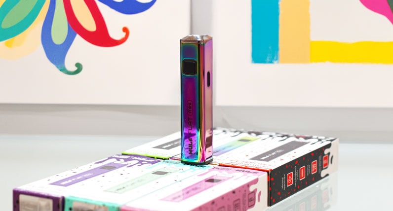 Wulf Flat Mini with colorful background and white table
