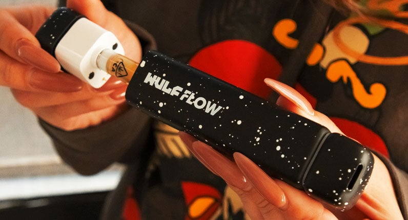 Woman in hoodie loading cartridge into Wulf Flow