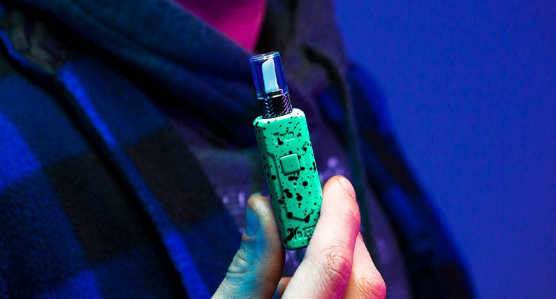man in sweater holding the Wulf Kodo Hot Knife on blue background