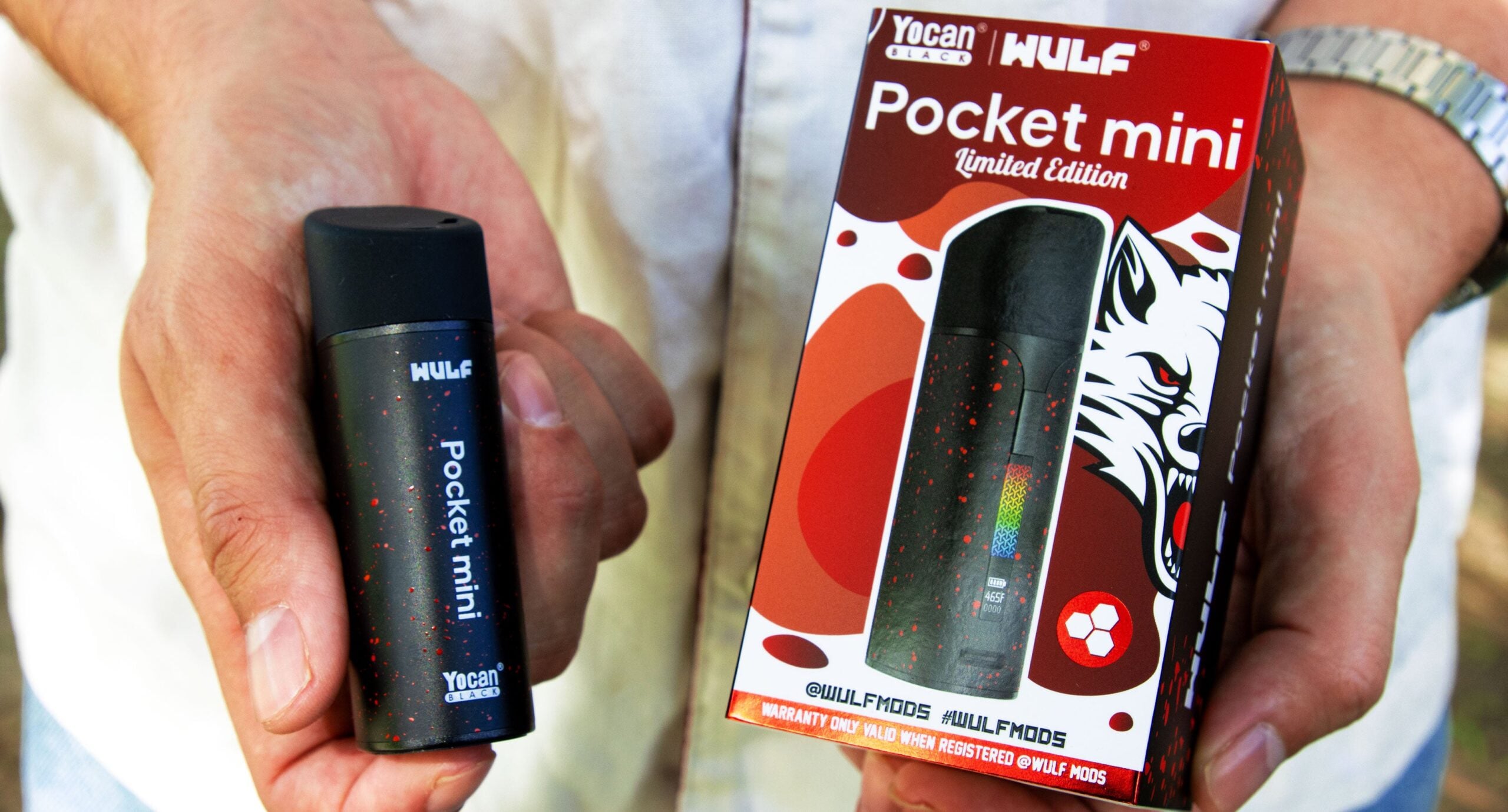 wulf pocket mini black red spatter with box held in hands outside
