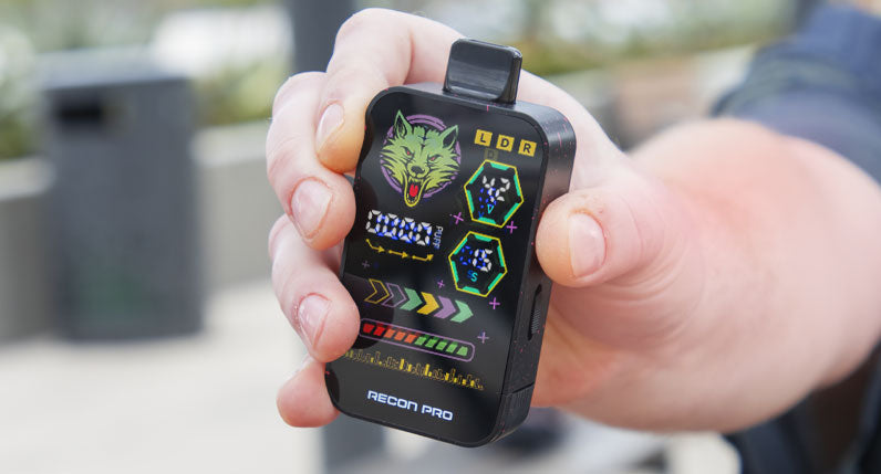 Person holding a WULF Recon Pro dual 510 thread battery with its colour screen lit