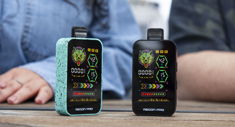 Two WULF Recon Pro dual 510 thread batteries in teal and black on a wooden table