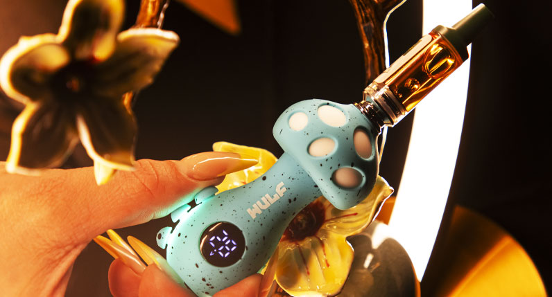 Hand holding a teal WULF TRYP mushroom shaped vaporizer