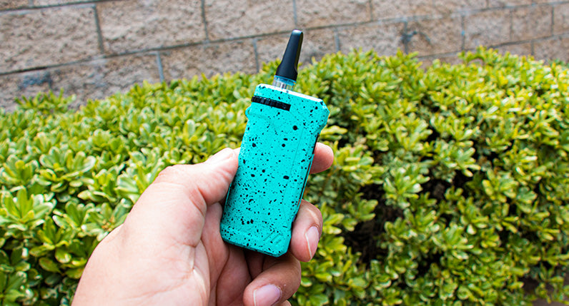 Teal and black Wulf UNI in someones hand