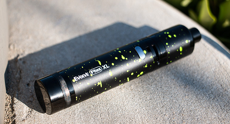 WULF Evolve Plus XL concentrate vaporizer in black with green spatter, side view
